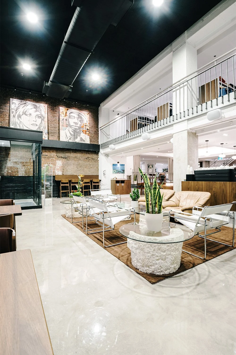 Double-height lounge area inside Empire café designed by Finkel', featuring custom seating and an open, modern hospitality interior