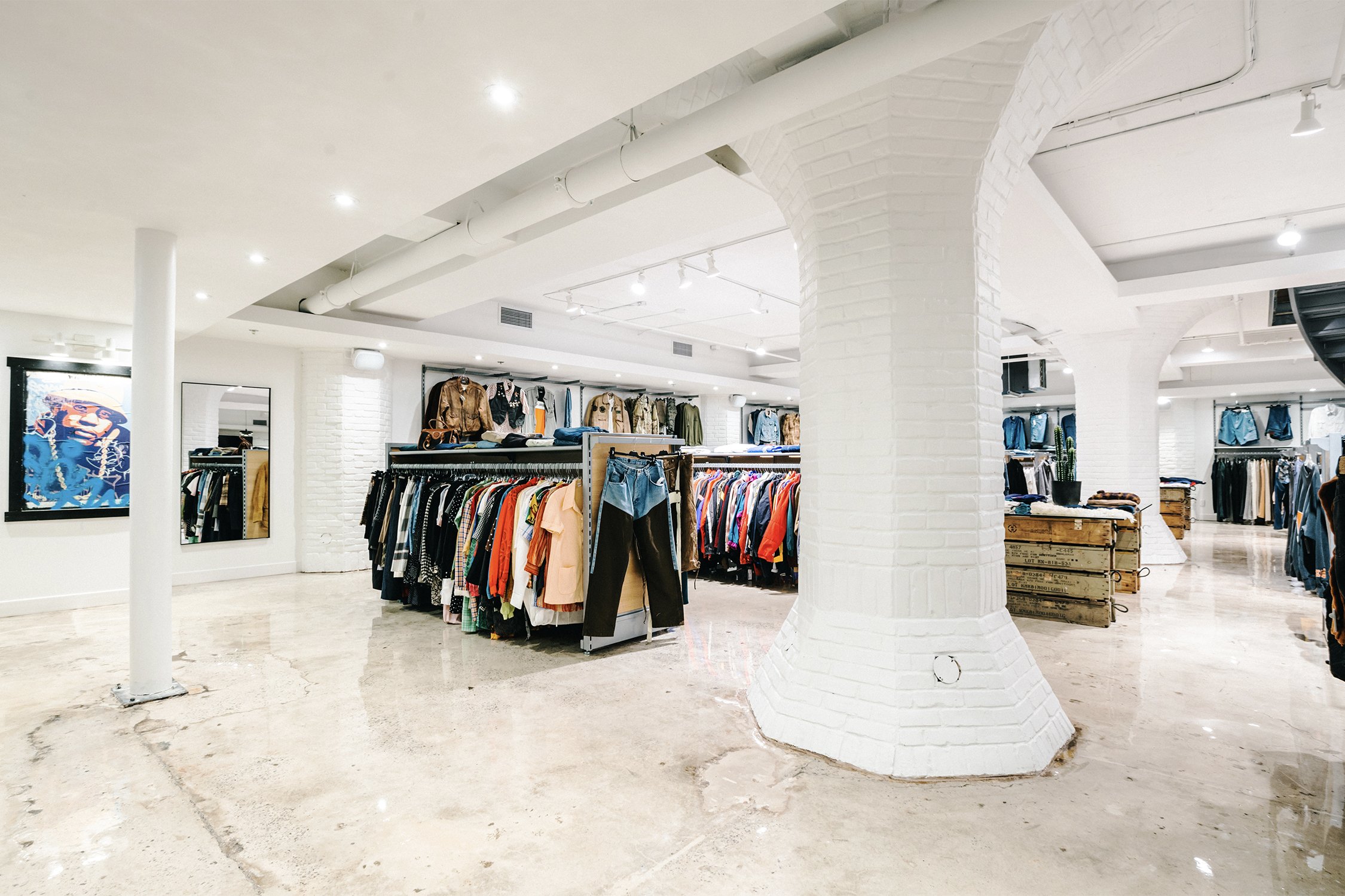 Open retail floor with structural columns and clothing displays designed by Finkel' for Empire’s flagship store