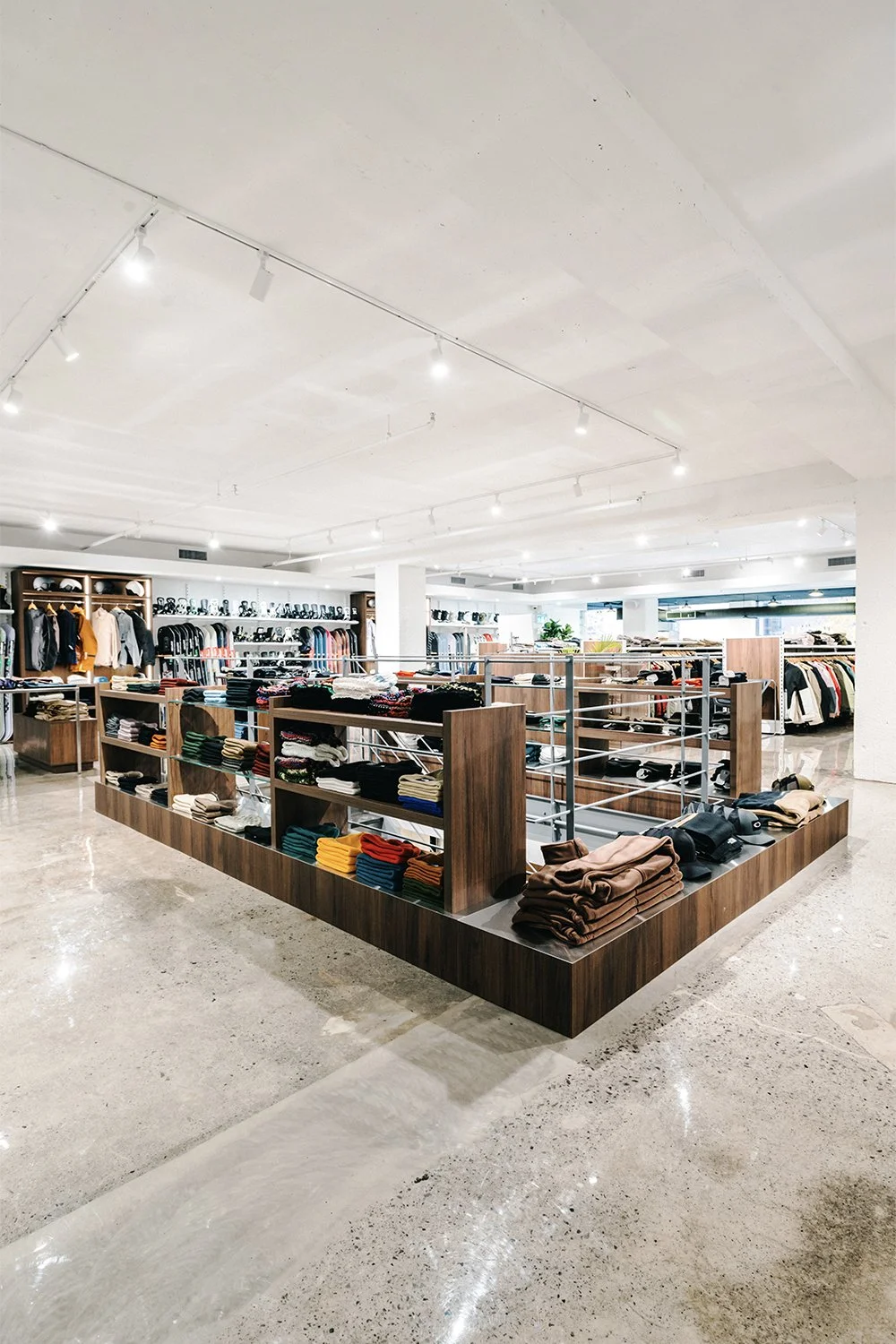 Empire flagship retail interior by Finkel' featuring custom display fixtures, open merchandising layout, and contemporary commercial design