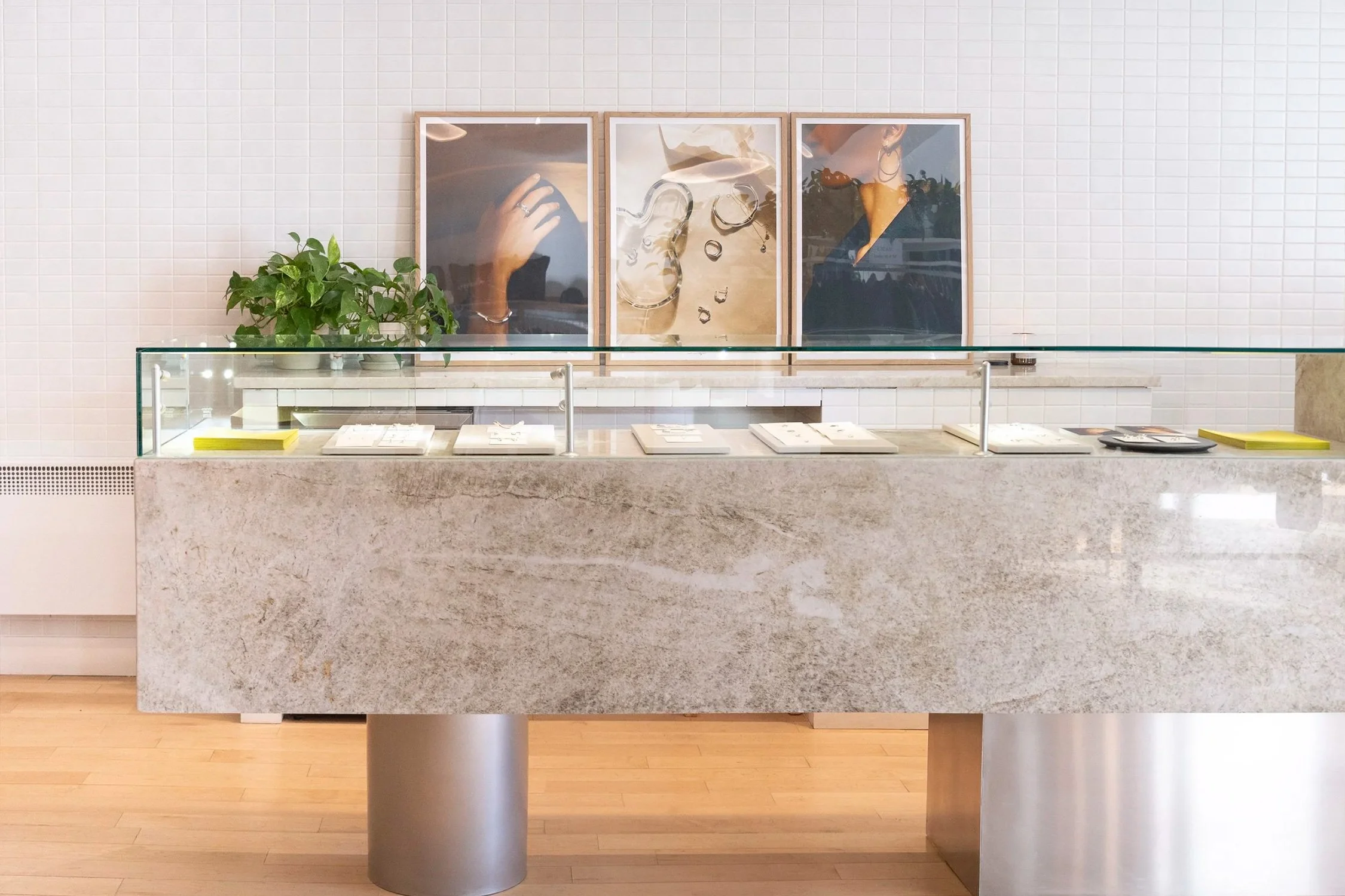 Custom stone retail counter designed for boutique interior with integrated display and glass top