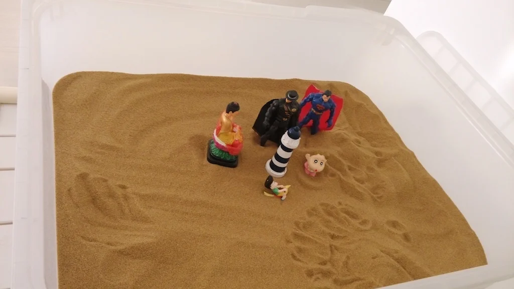 "These are the Gods!. They are all Gods, aren't they, the Buddha, Superman and Batman?" But, the tower watches us all." Who is the boy? I ask. "I dunno. Maybe me... It is how I feel when I miss my father." (R, 9 y/o)