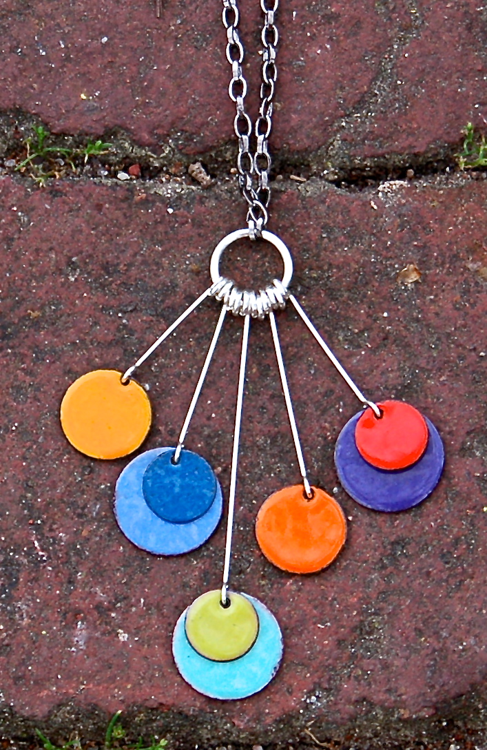 This dramatic pendent piece works well with either solids or patterns. Wear this with a dress in the same blue / green family - or go wild and wear it with pink, red or orange. Wear it with black and you won't be able to get down the sidewalk without people telling you they love your necklace.