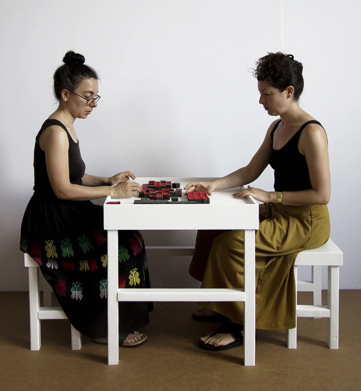 Invitation to Play : Open | Close | Open , interactive installation at the Bronx Museum of the Arts, July 22 - October 22, 2017 79 small ceramic vessels constitute game pieces in a moveable grid, representing organs in the human body. The title is lifted from a poem by Israeli poet Yehuda Amichai that reflects on states of being open/closed/open during pre-birth/life/death, respectively. During Performance sessions I invite visitors to play with me. They make the first move and determine the length of the game. The game has no rules. Excerpts from these interactions: