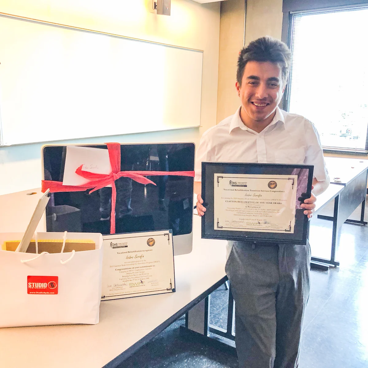 Isidro with his SWIFTY of the Year Award (and some gifts from his mentors - Brian & Sandy.