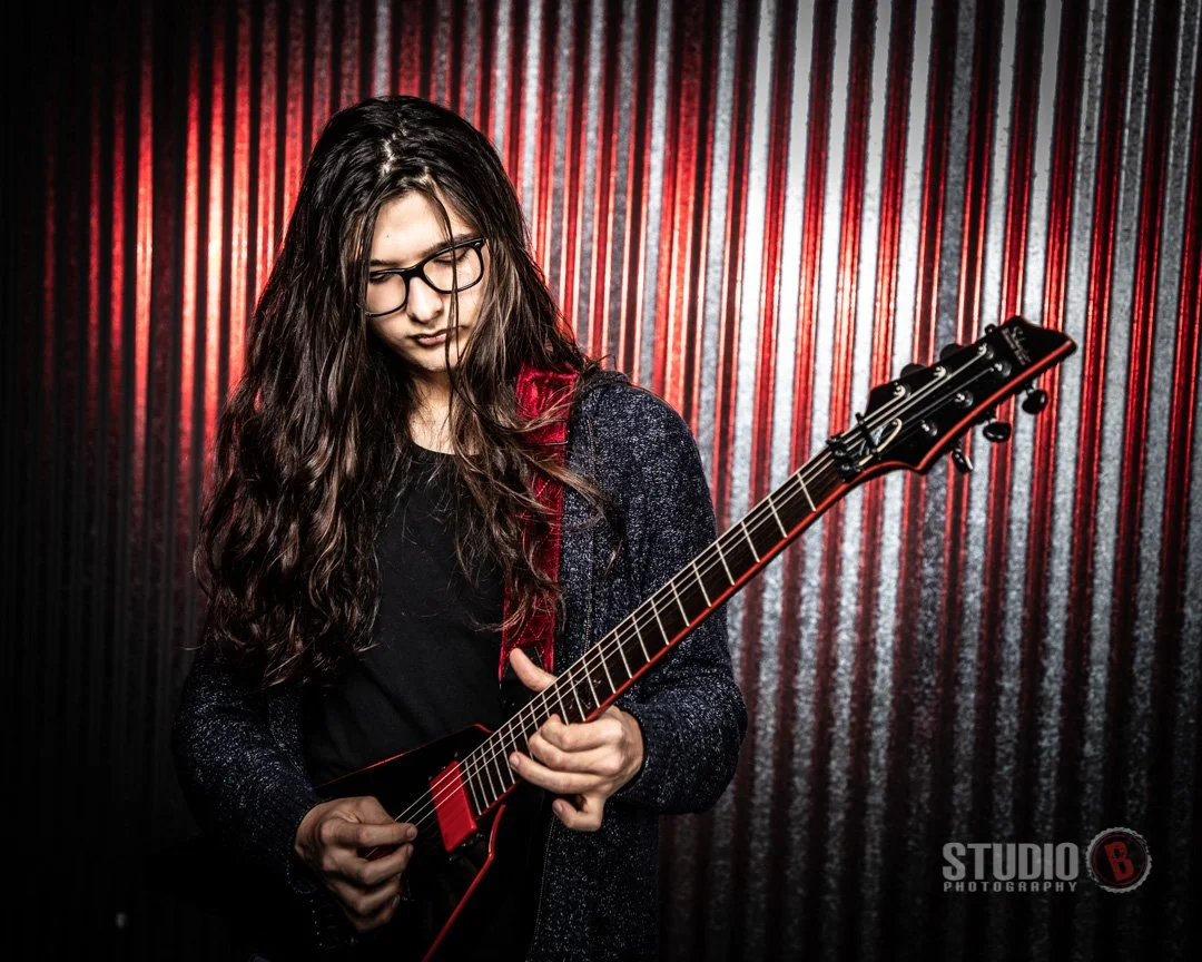 senior guy at portrait studio dark background with a guitar in Lake Oswego