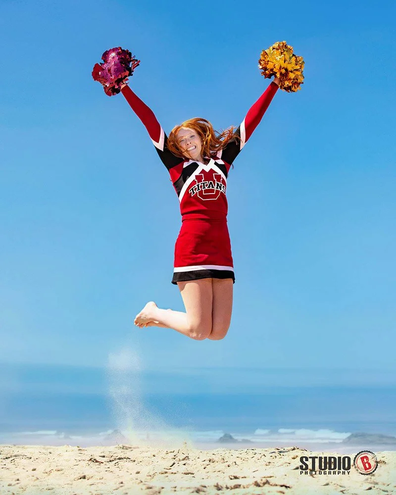 High school senior cheerleader portrait blue sky at Oregon coast.