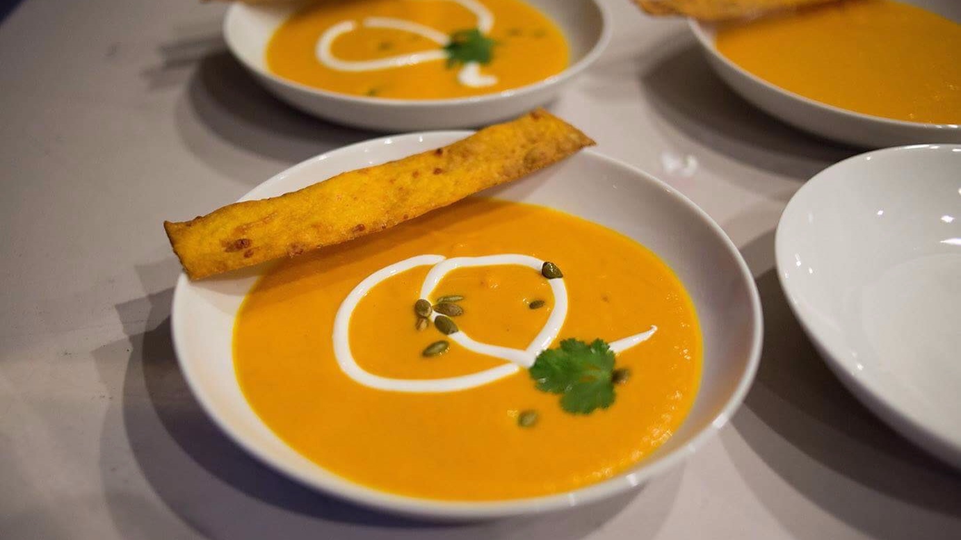 Curry butternut squash soup and homemade carrot crisps.
