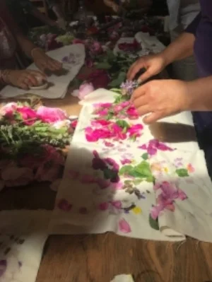 Henrietta mixing botanicals for scent before tapping them for scent.