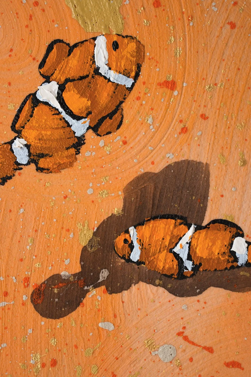 Modern coastal wall art featuring a scattered school of clownfish by New York City based painter Josh Brown.