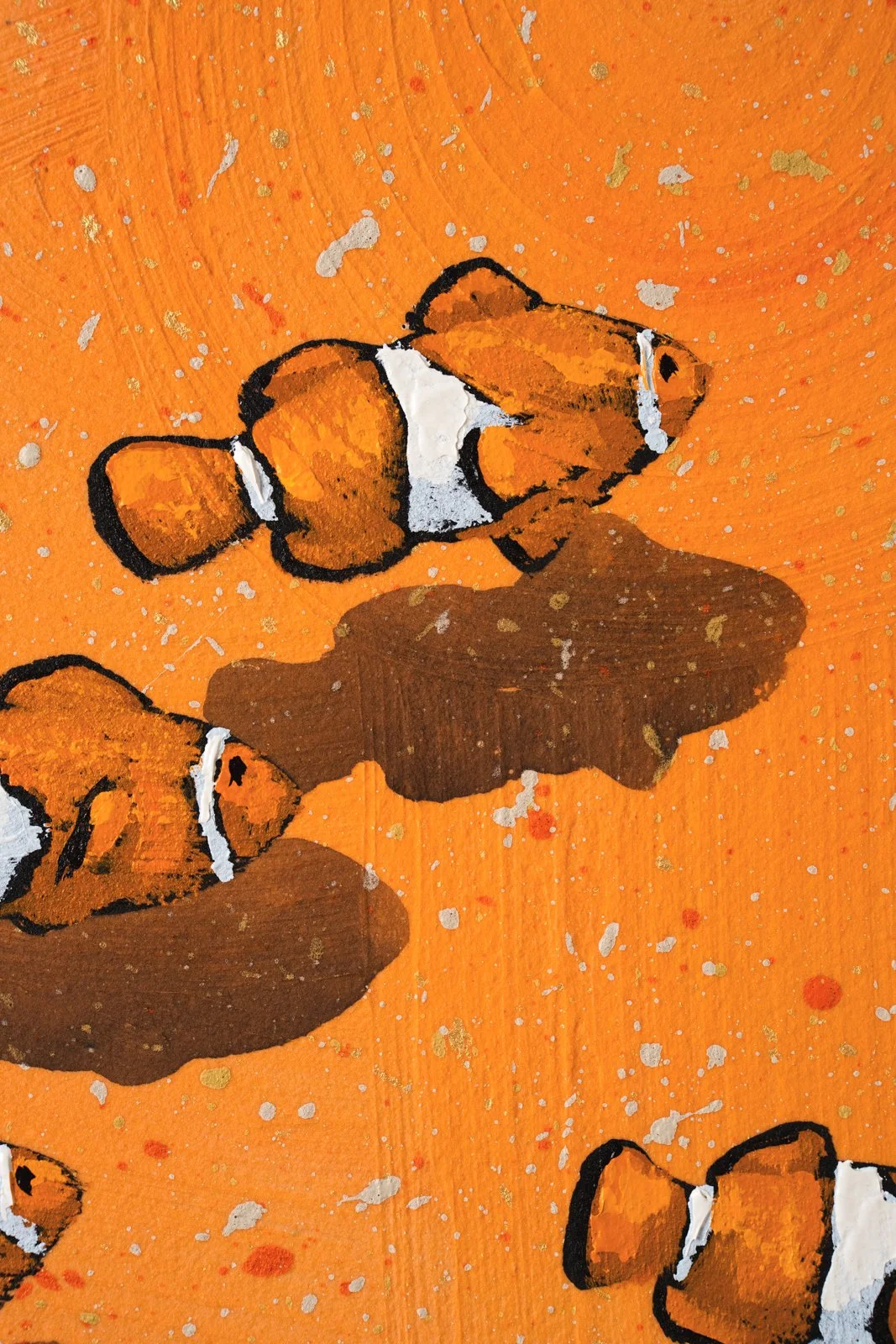 Contemporary marine animal painting with repeating clownfish motifs, cropped to reveal three fish by Josh Brown.