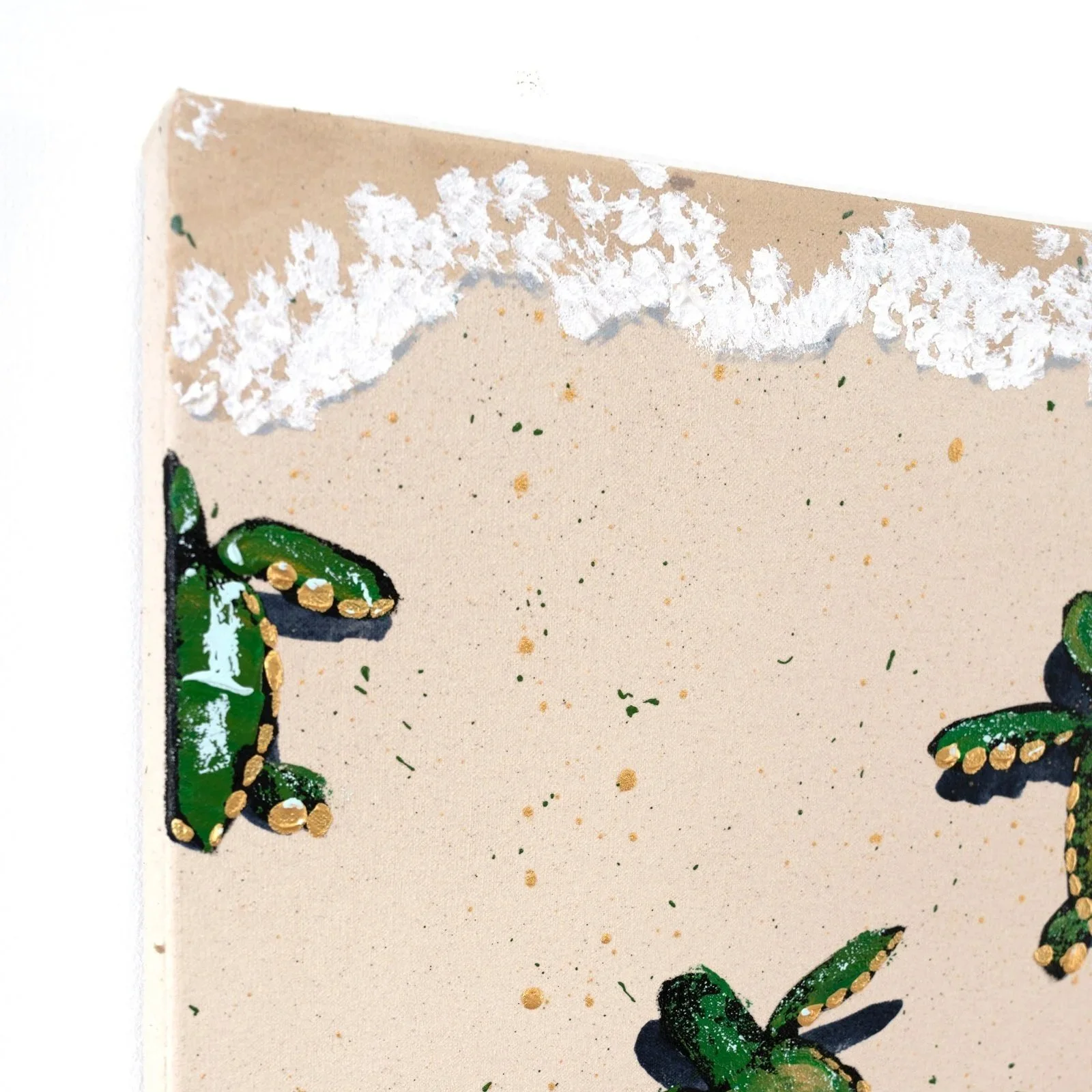 A cropped imaged of a large acrylic painting of sea turtles wading into the surf in brilliant shades of green and gold on a sandy background by NYC based painter Josh Brown.