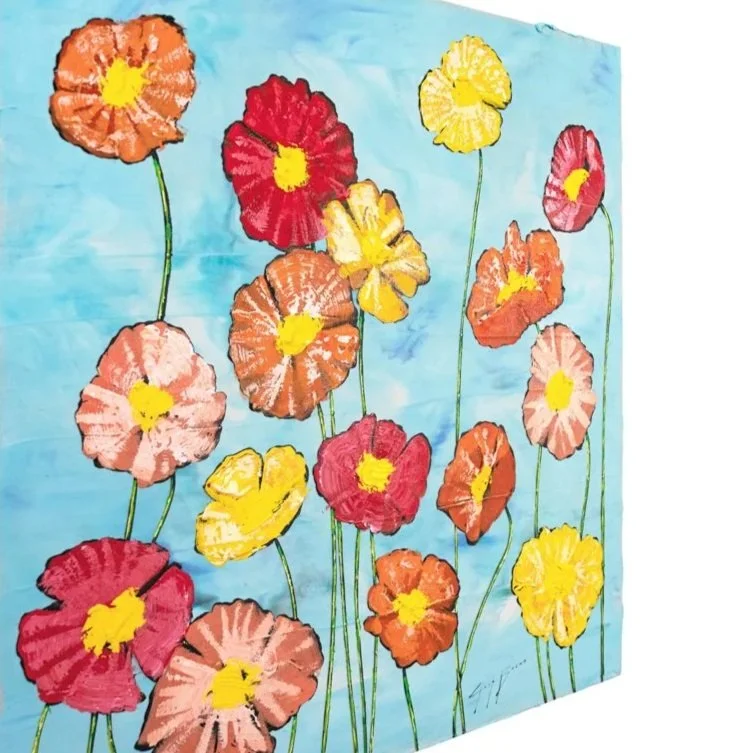 Square-format floral painting with bold warm-toned flowers set on a soft blue field at an angled view by Josh Brown.