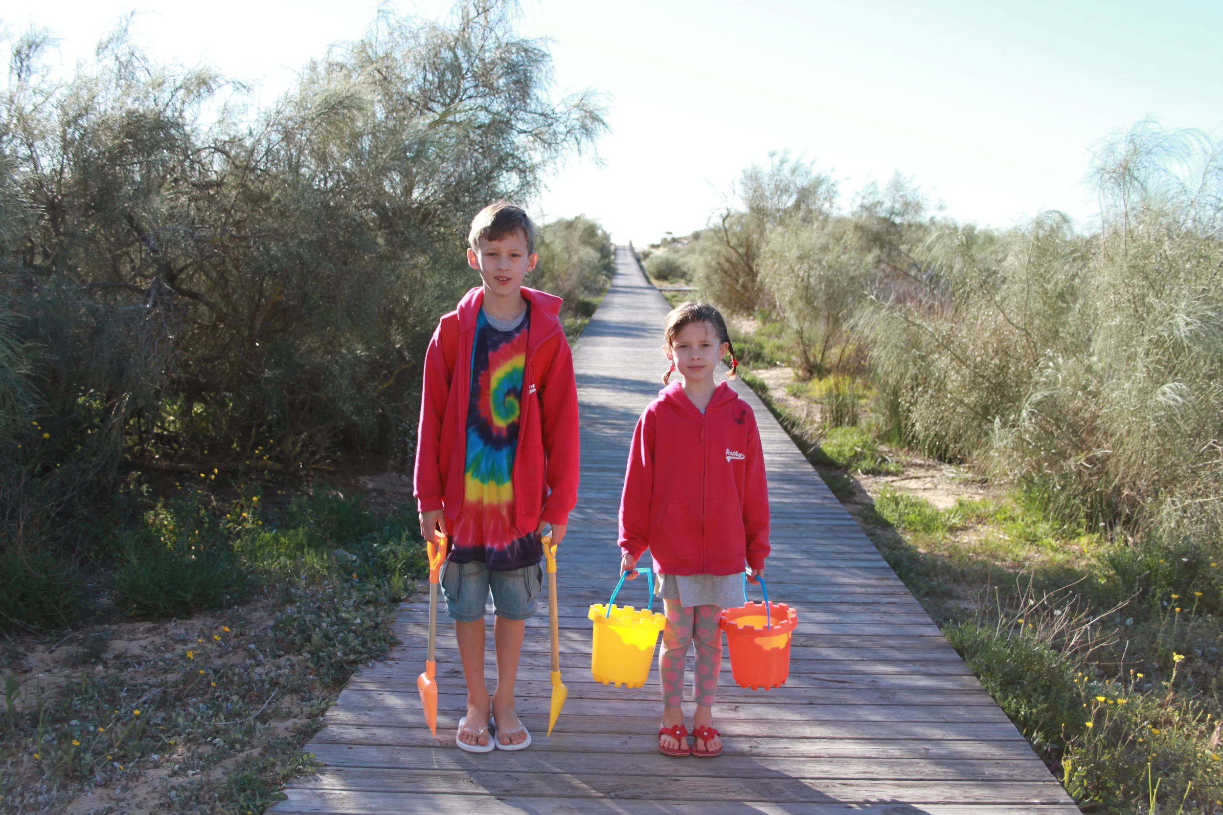 Truman (8) and Martha (6) off to dig holes on the beach in the early morning sunshine...