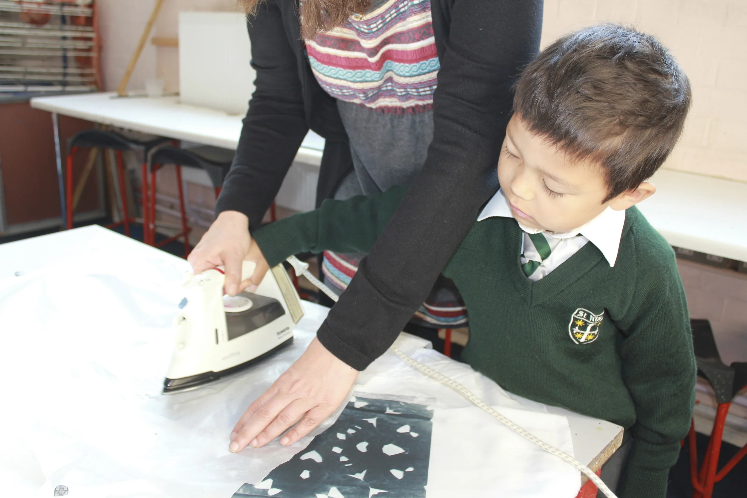 Using black transfer paper, folding and cutting a simple doily, and then using tissue paper and an iron