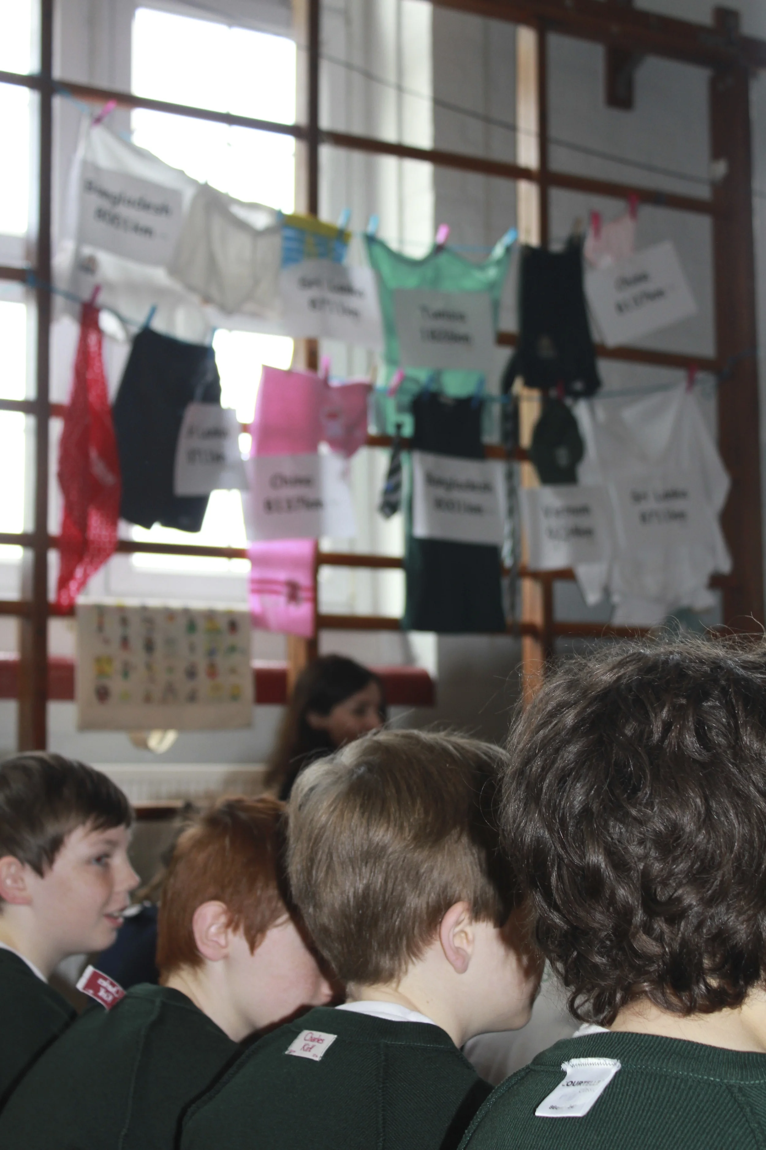 School assembly, 24th April 2014, and the #insideout campaign comes to Chiswick. Staff and students wore their uniforms inside out for the day. Mrs MacManus, deputy head, presented films showing child labour in Asia, and the pupils said prayers for those that lost their lives at Rana Plaza, and their families. (Read about Charles Kirk, the maker of our school jumpers here )
