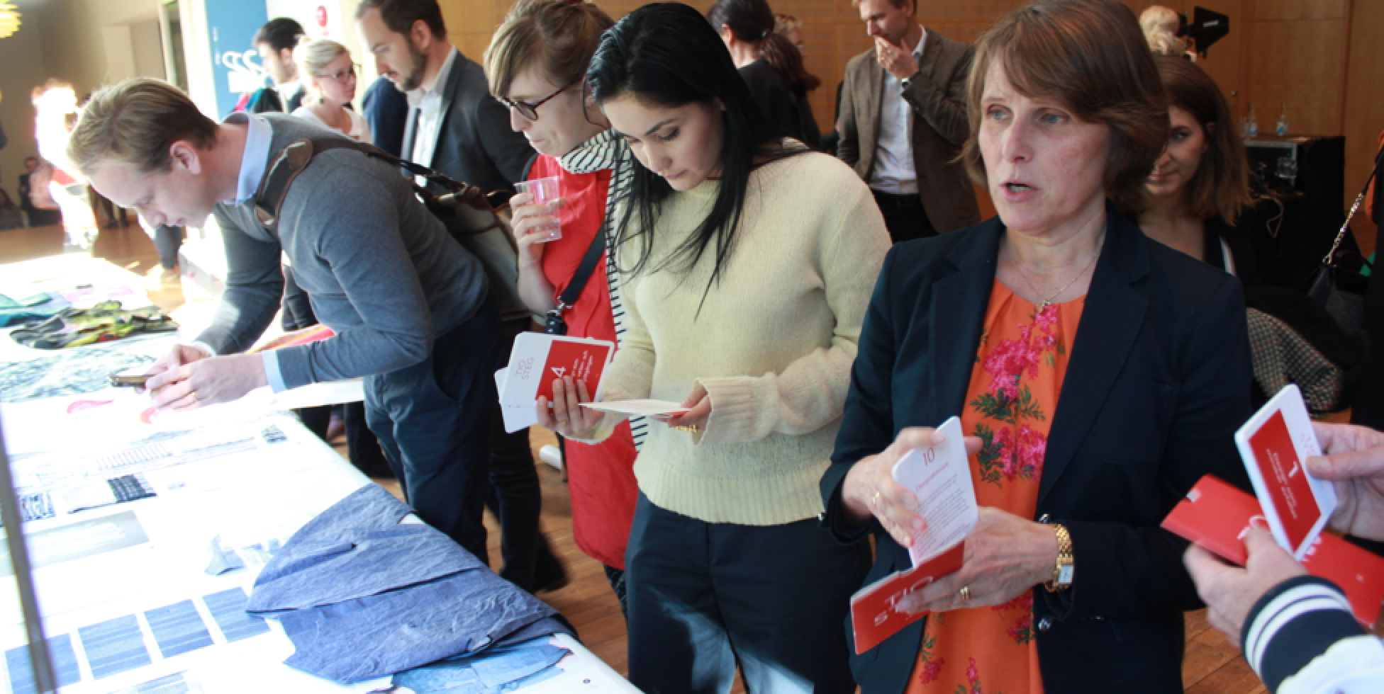 Industry visitors look at the Textile Toolbox work and the Swedish language TED's The TEN cards, at the launch of the Mistra Future Fashion Manifesto, held at Stockholm School of Economics, September 2015.