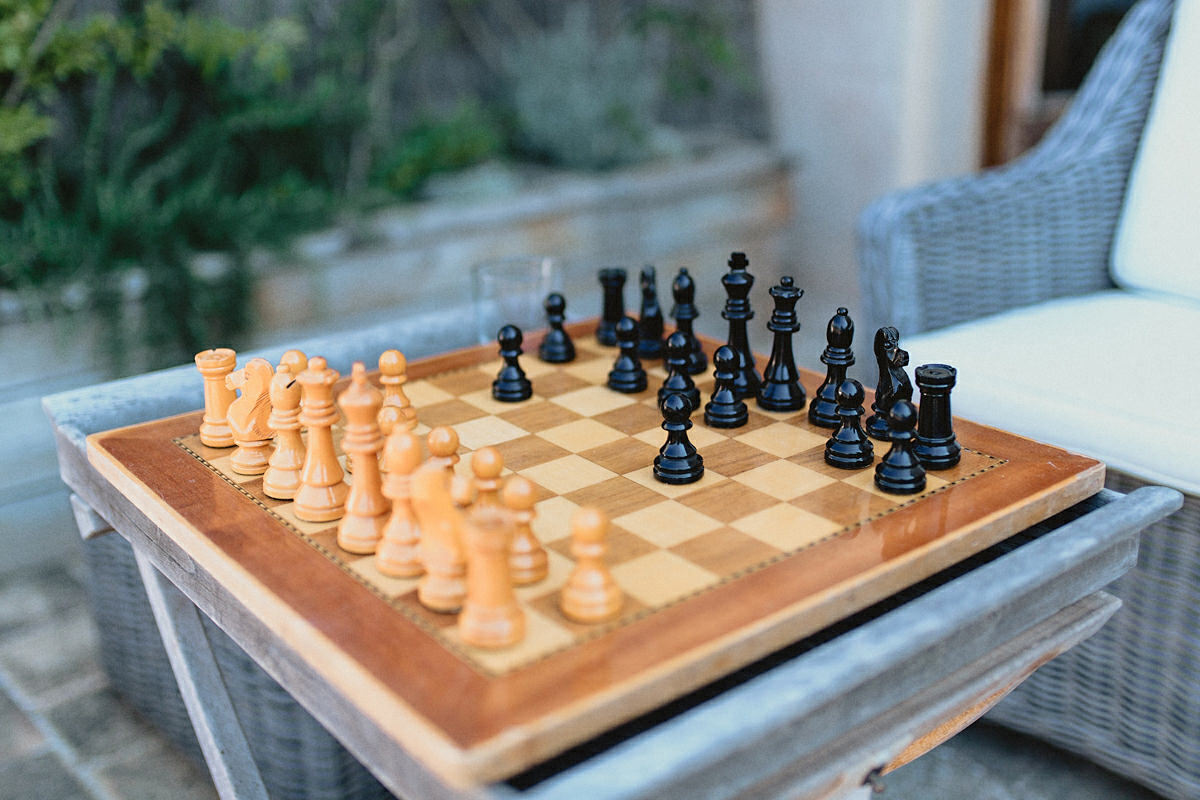 Groom and batsman playing chess