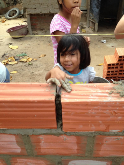    A young family member helping with the construction of her new house.   