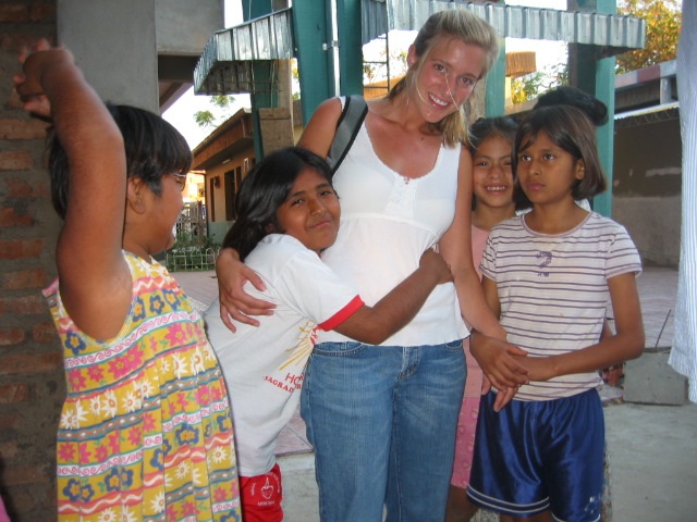    A volunteer playing with girls at the orphanage.   
