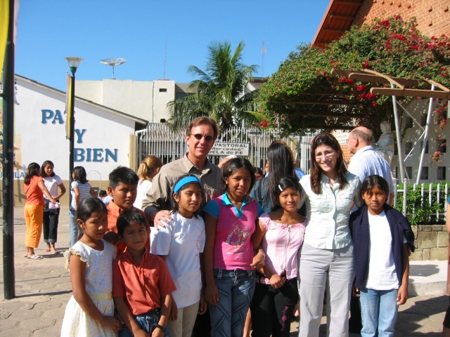    Volunteers and children outside of the orphanage which is located next to the Catholic church.   