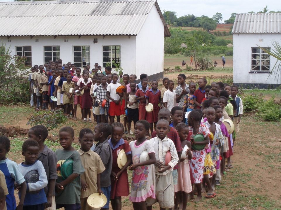   Students wait in line for their daily donated lunch which is part of our Feed Program. &nbsp;It's often these kids go hungry and don't have the energy to walk to school. &nbsp;The food program has helped enormously with attendance rates, as well as