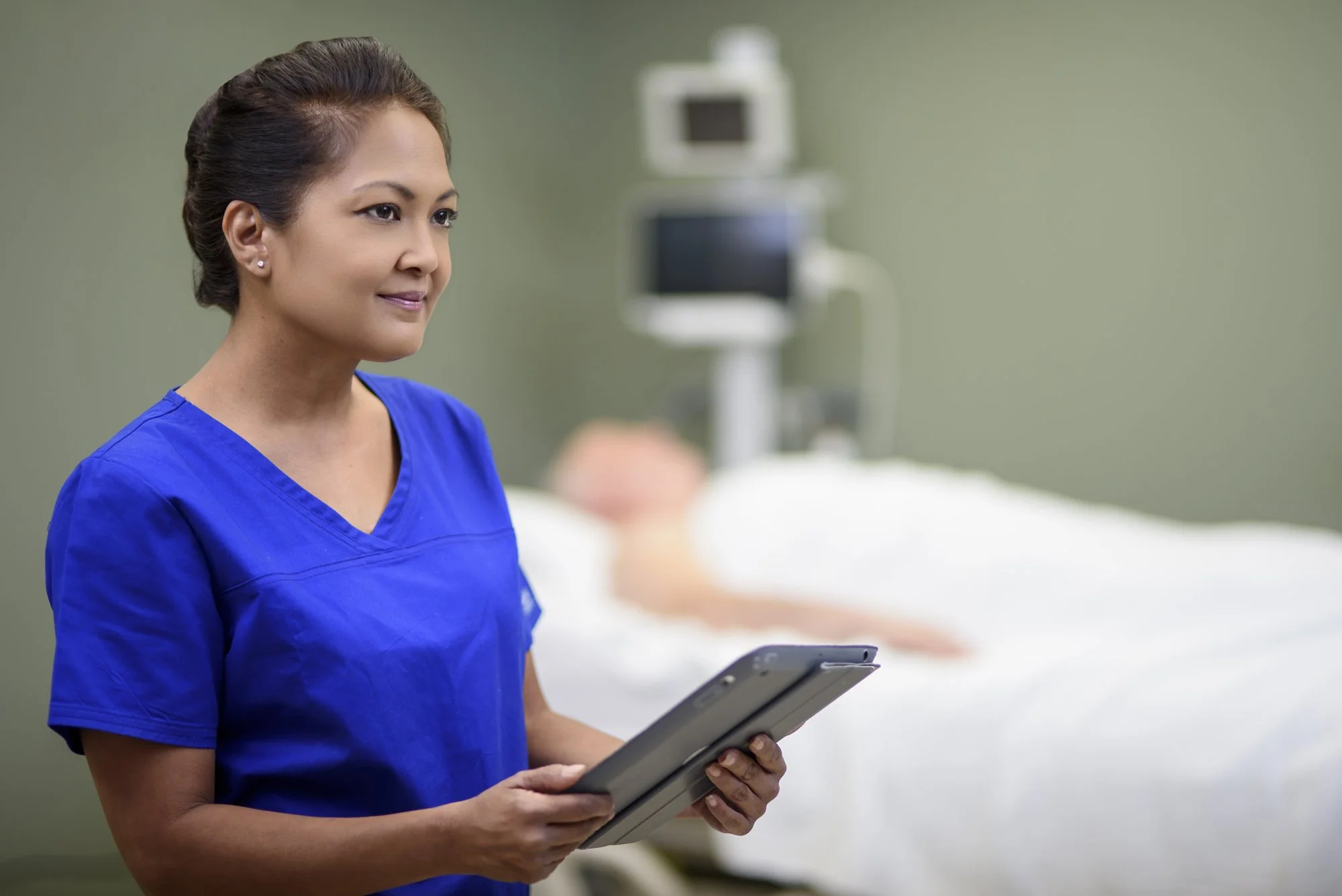 Nurse using tablet in patient room.jpg