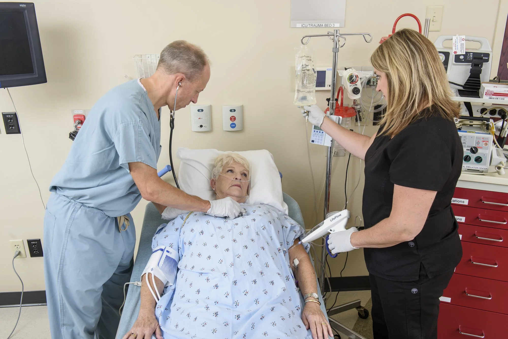 Medical team assisting elderly patient.jpg