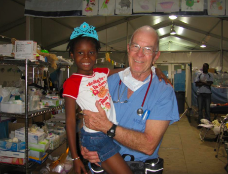 Dr. Miller with a child in Haiti after the 2010 earthquake.