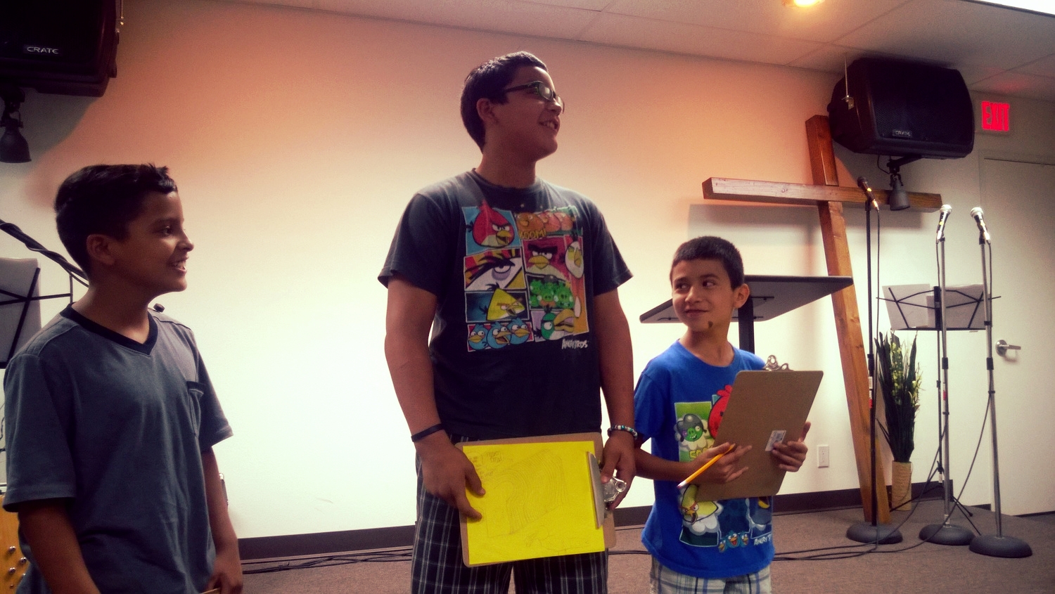 Students presenting their Bible verse drawings.
