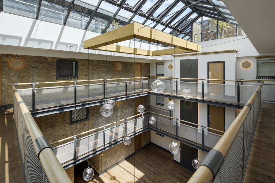 Wharf side apartment building atrium with bespoke industrial light feature - Wapping