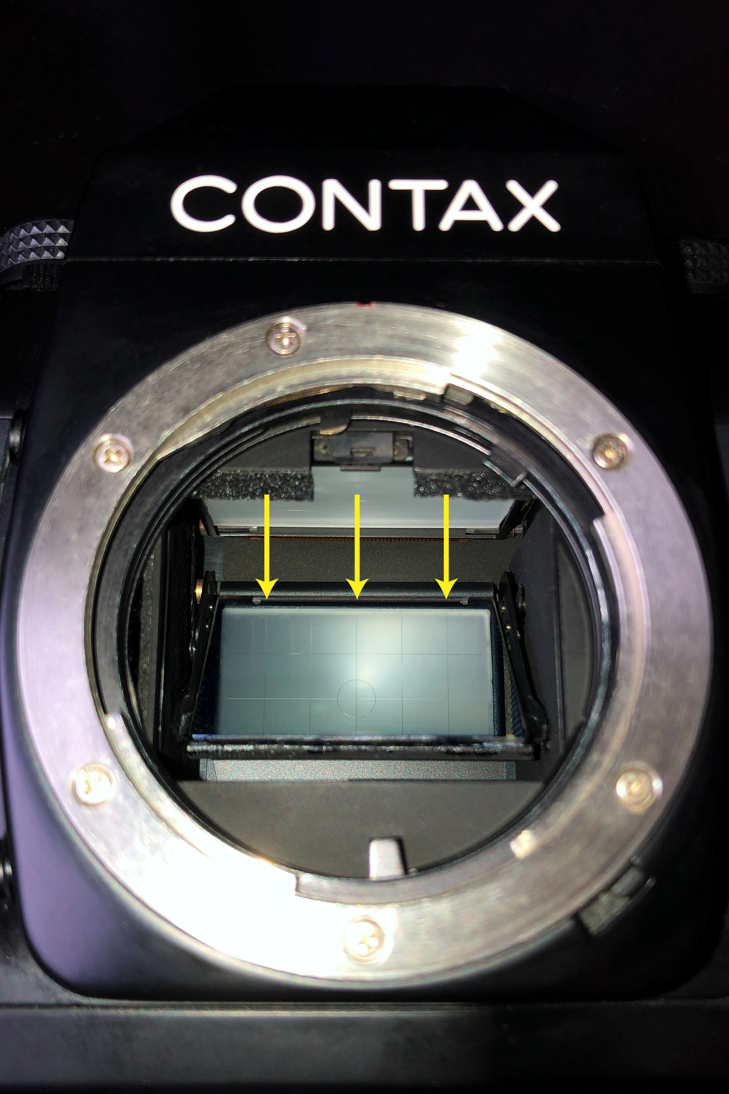   Yellow arrows indicate the area where I applied a 3cm long piece of adhesive transfer tape across the back edge of the carrier plate using tweezers. The hardware store recommended adhesive transfer tape rather than double-sided tape as it is thinne