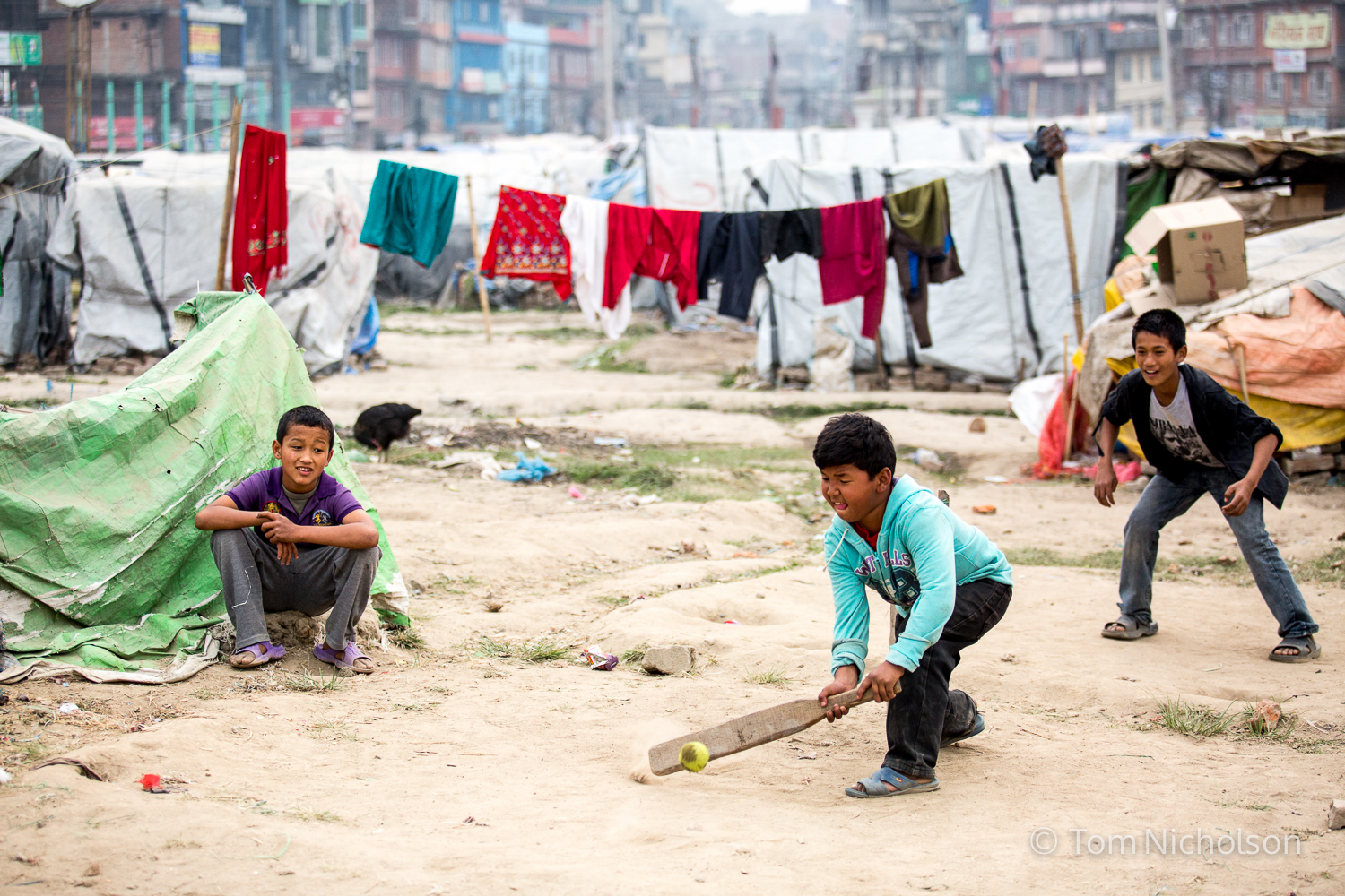 Children play cricket in the Internally Displaced Person (IDP) camp in Chuchepati, Kathmandu City, Nepal on 27 March 2016. The camp houses people in temporary accomodation due to the April 2015 earthquake.