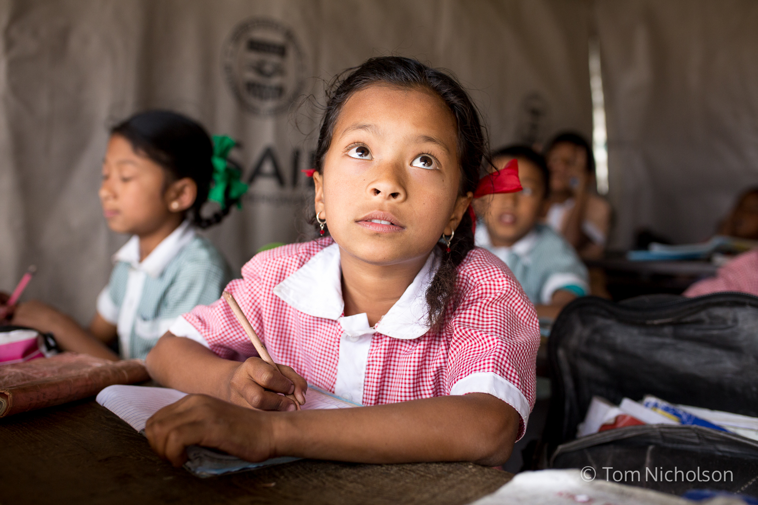 Children study in temporary classrooms at the Tri Ratna Cooperative School, also known as Bungamati School, in Bungamati District, Kathmandu, Nepal on 17 March 2016. Their previous classrooms were destroyed by the April 2015 earthquake.