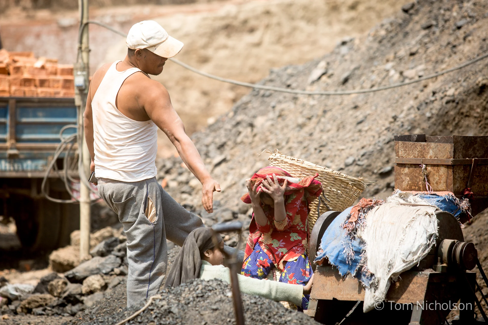 A child is hit by the supervisor in the UK brickworks factory in Bungamati, Kathmandu, Nepal on 15 March 2016. Around 400 labourers, including children, work in very dusty and hot conditions.