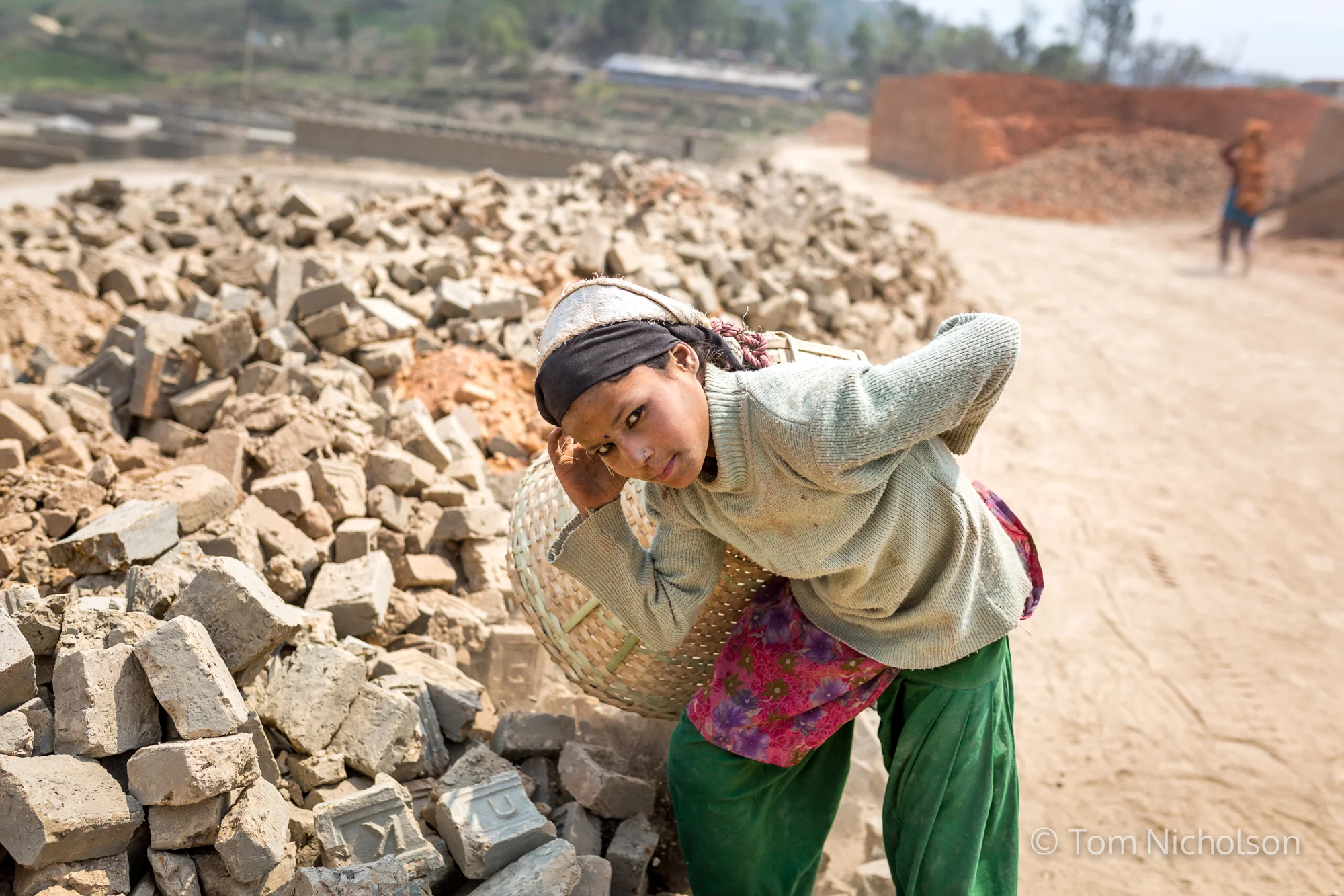 Children move bricks in the UK brickworks factory in Bungamati, Kathmandu, Nepal on 15 March 2016. Around 400 labourers, including children, work in very dusty and hot conditions.