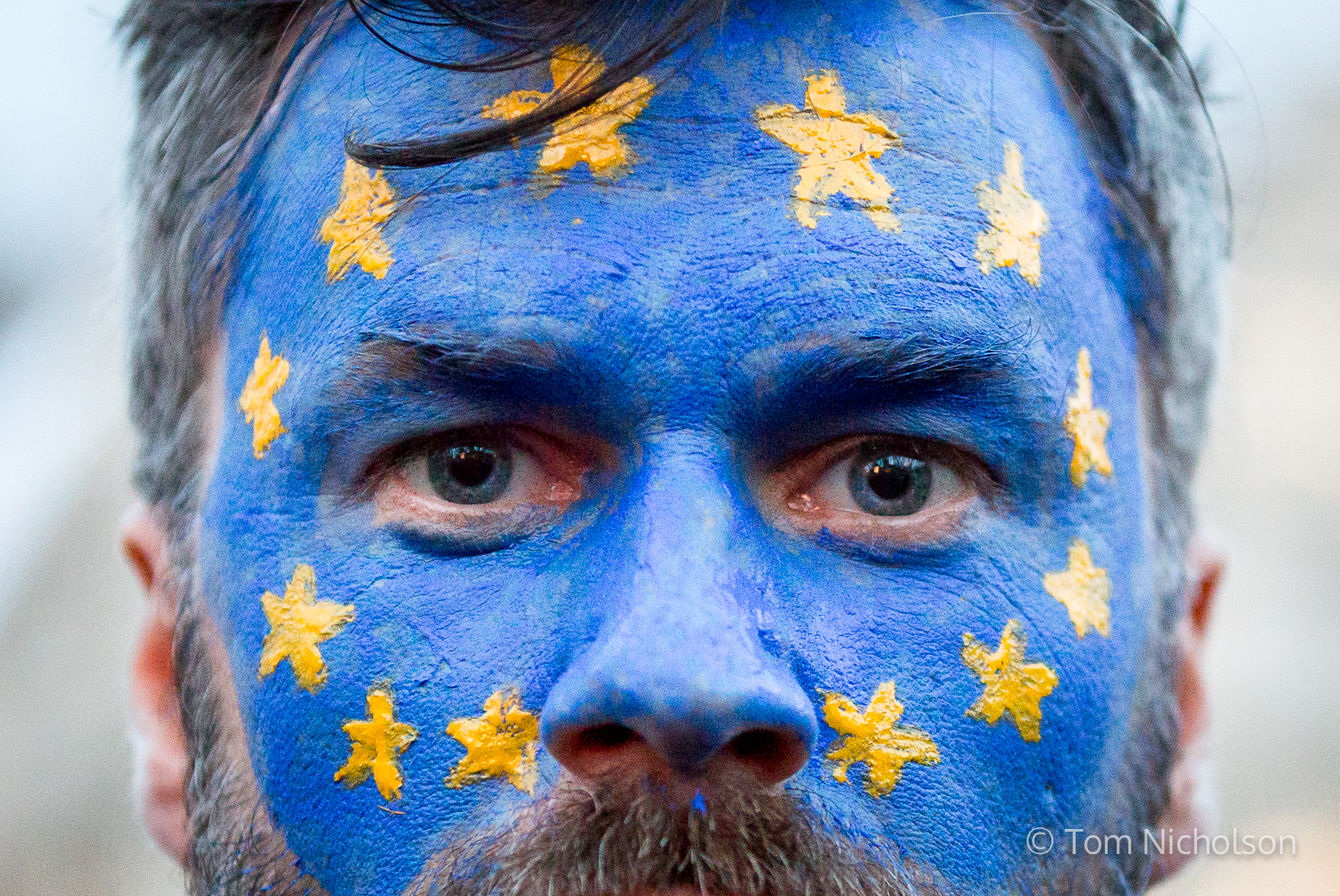 ©2017 Tom Nicholson. 20/02/2017. London, UK. A demonstrator with his face painted with the European Union (EU) flag protests against Donald Trump, whilst parliament debate a petition calling for the US President's state visit to the UK to be cancelled.