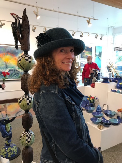 Cay, a Fort Bragg local, posing with her new purchase from our newest artist and designer of hats: Tess McGuire.