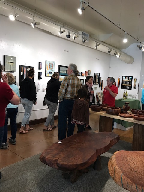 Guests admiring Steve Chell's art, Edgewater's Featured Artist.