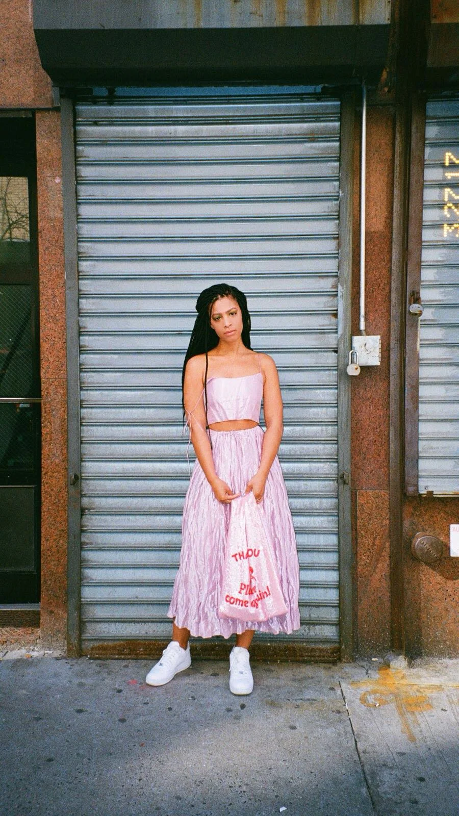 Claire Leana Millar in Chinatown Manhattan wearing pink metallic set, and box braids
