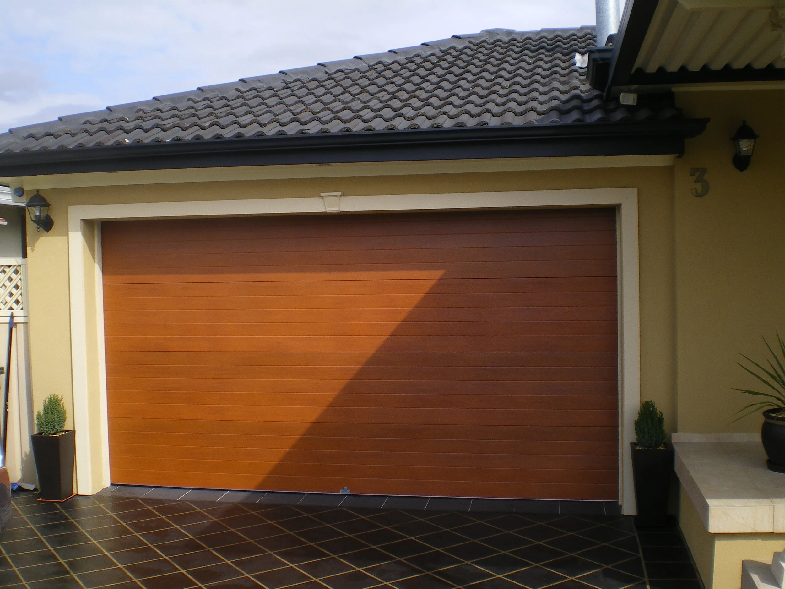 "knotwood" Australian cedar steel sectional door (click on image to enlarge)