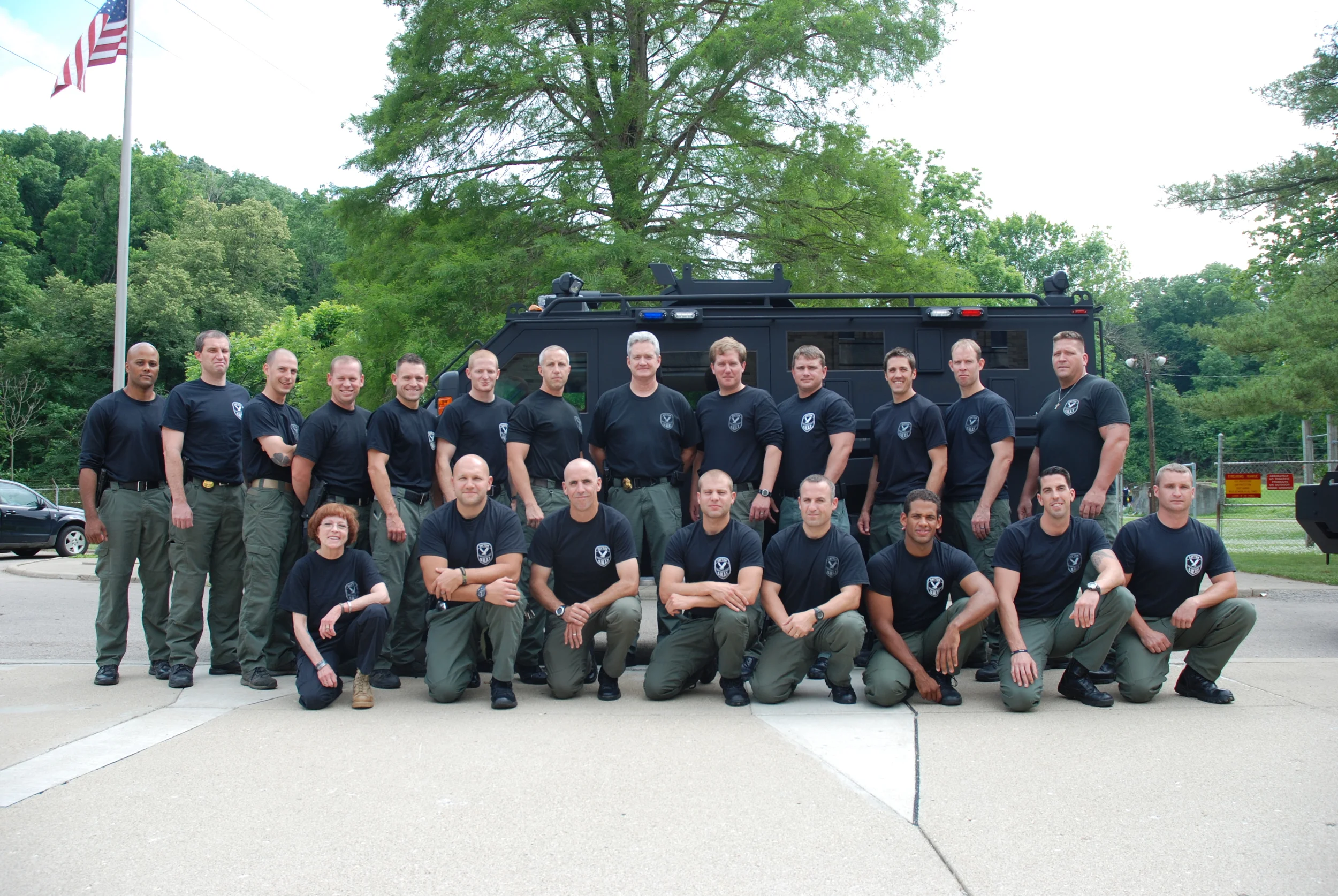 Dr. Platoni (Far Left, Kneeling Row) poses with the Dayton SWAT team.