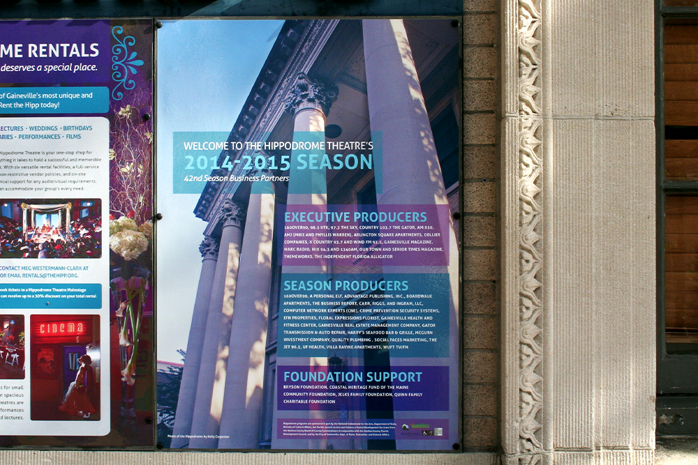 Posters displayed on front wall of the building.