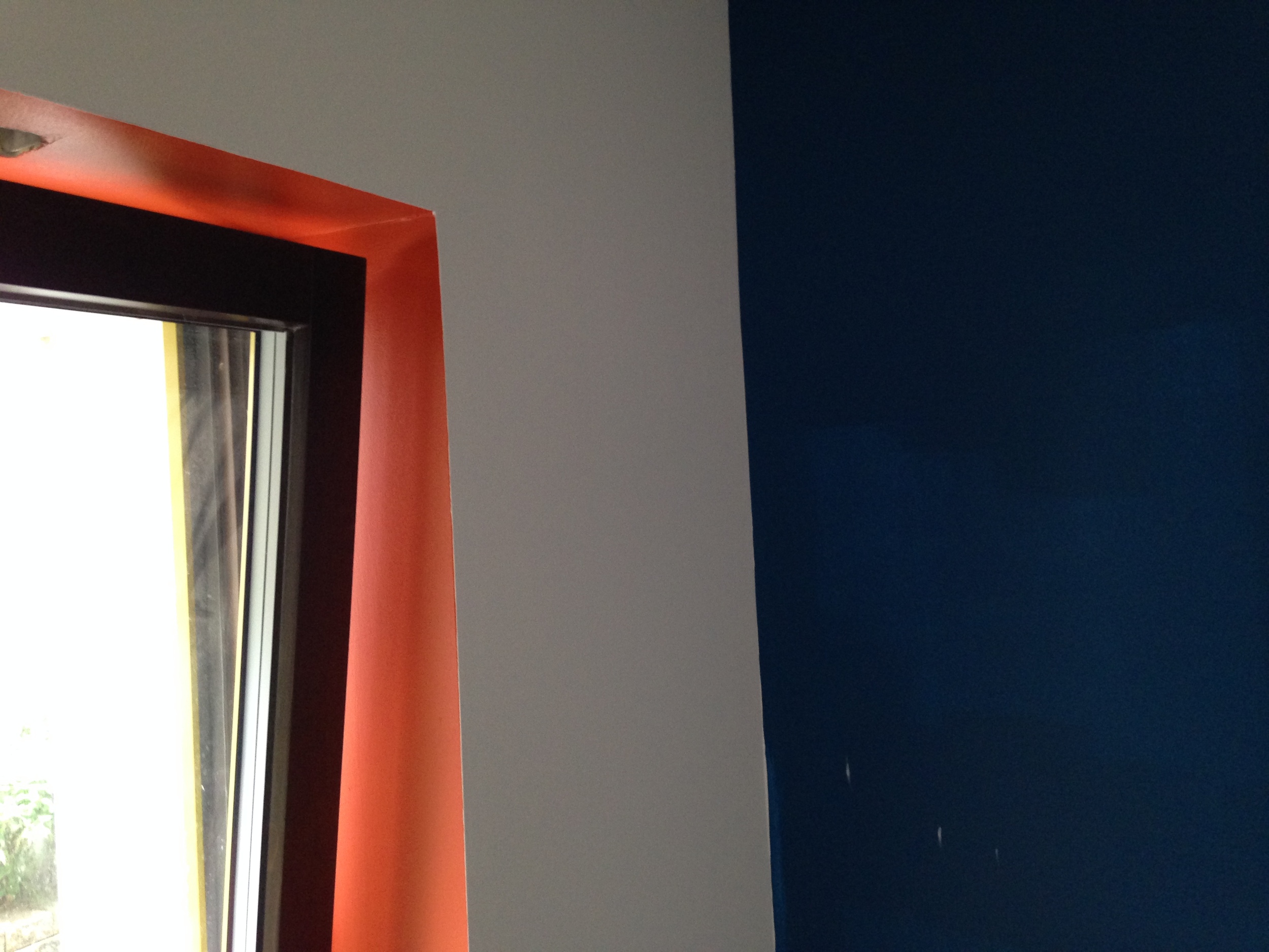  Window seat in the den with a pop of orange.&nbsp; Blue wall will have white shelving/cabinets and the TV 