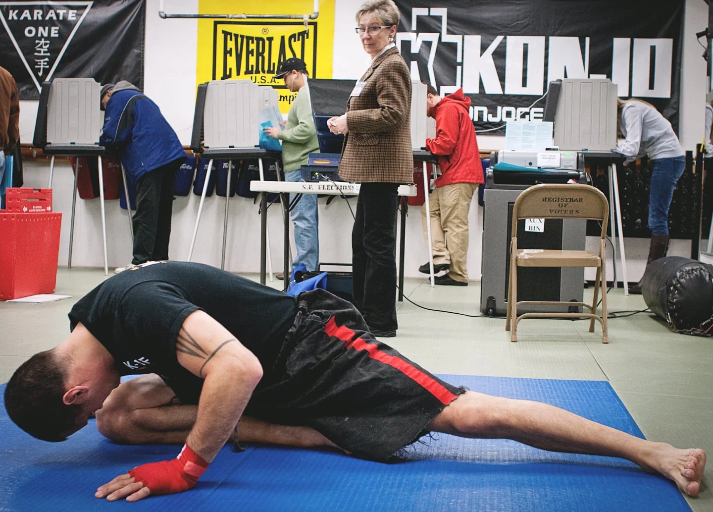  Voters across the Bay Area sometimes find their polling place is a little out of the ordinary, a necessity to meet demand on election day. Here, Jack Shanas stretches before his workout at the Martial Arts Fitness Center as the inspector of the poll