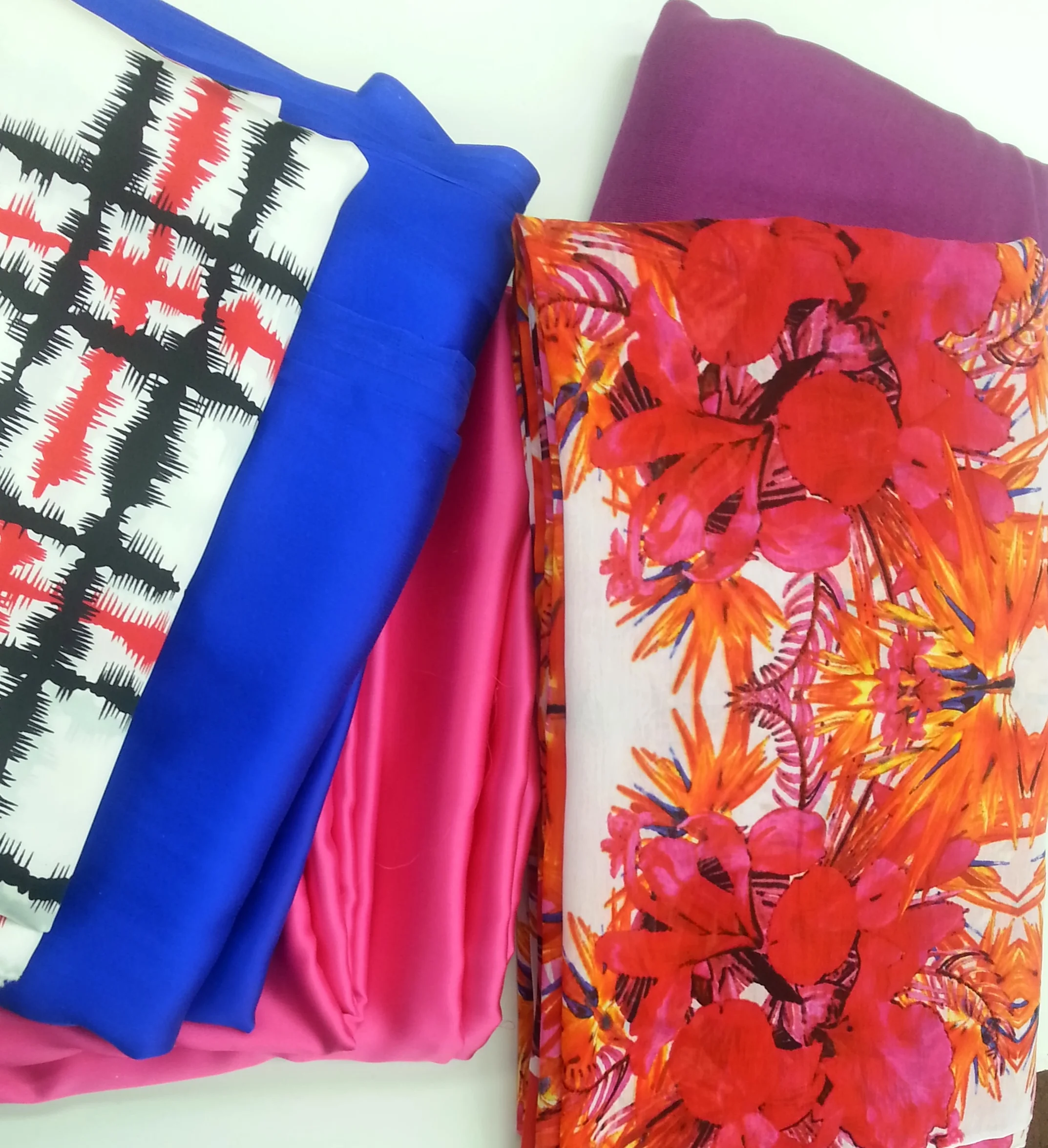4 ply crepe silk in white, black and red stripes, washed silk in Cobalt and Magenta, Floral silk + cotton, and jersey knit silk in purple