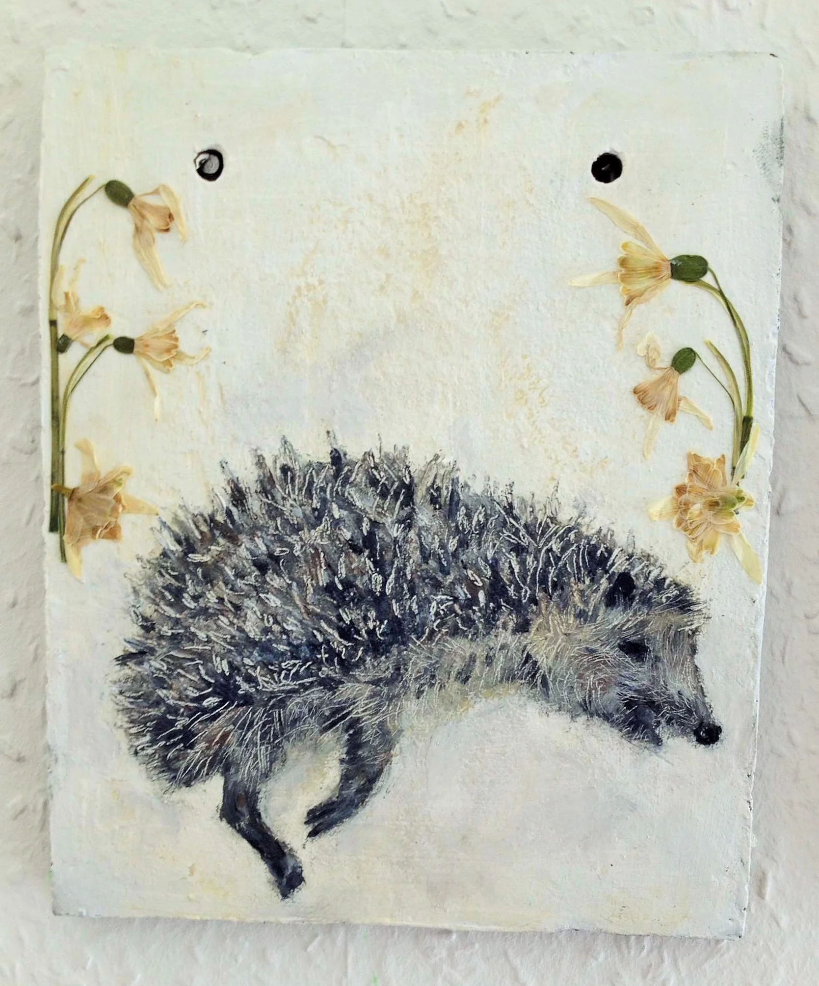 Terracotta tile shrine for dead hedgehog, with pressed flowers