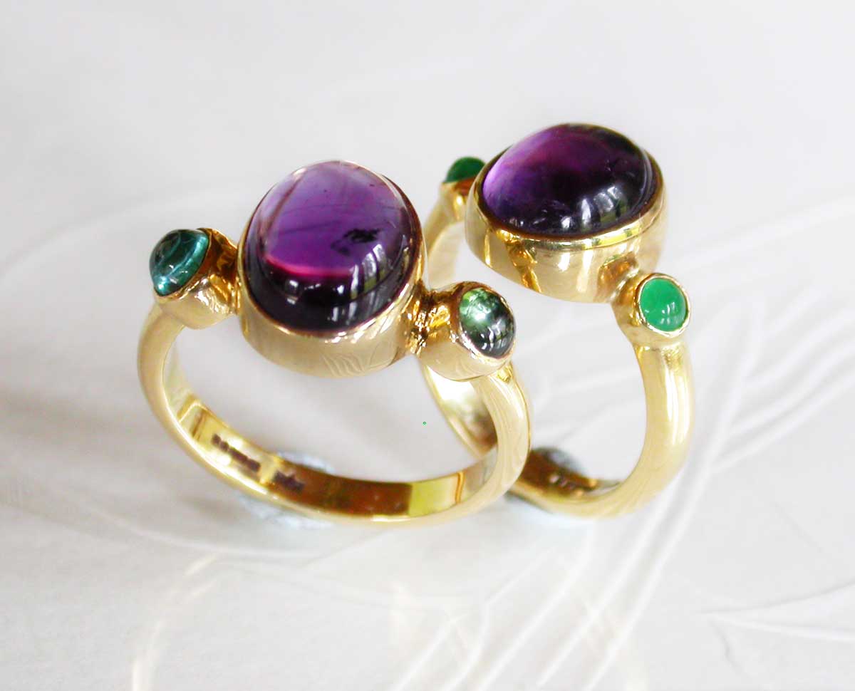 Gold rings set with oppulent precious stones