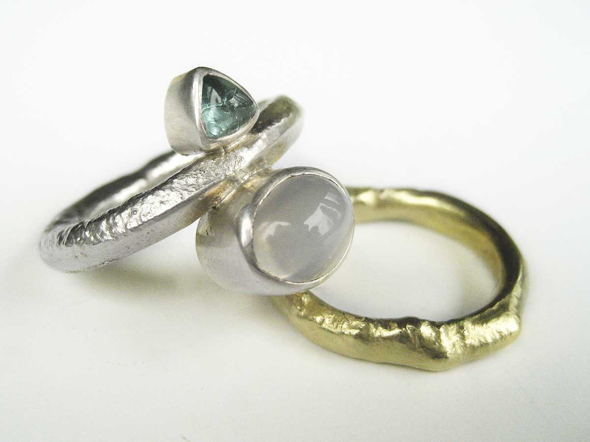 Silver and 18ct. gold rings with moonstone and tourmaline cabochon stones