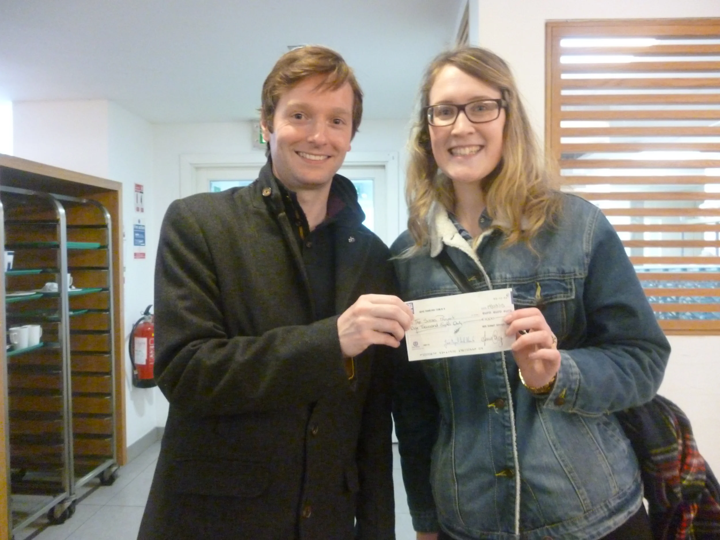 Colin McAvoy from Web Summit Dublin presenting Amy Ryan from Solas Project with a cheque for Solas @ School