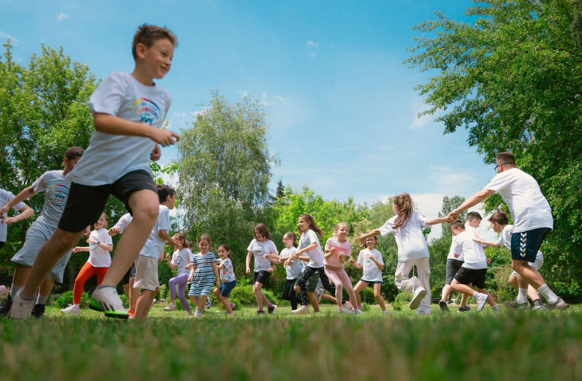 Children running on a grass field